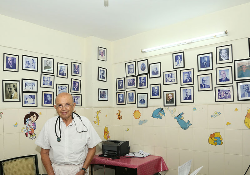Dr. Adenwalla smiling in his office