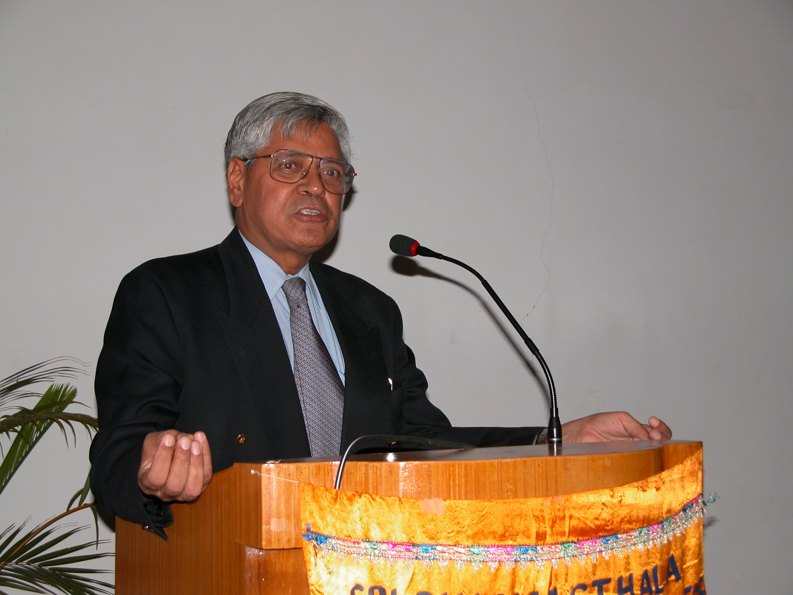Dr. Satish Kalra speaking at a podium