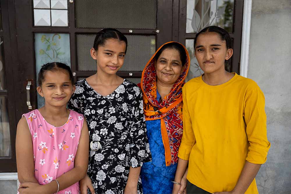 Kuldeep proudly poses with all three of her daughters