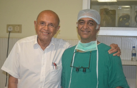 Dr Hirji Adenwalla smiling with a surgeon