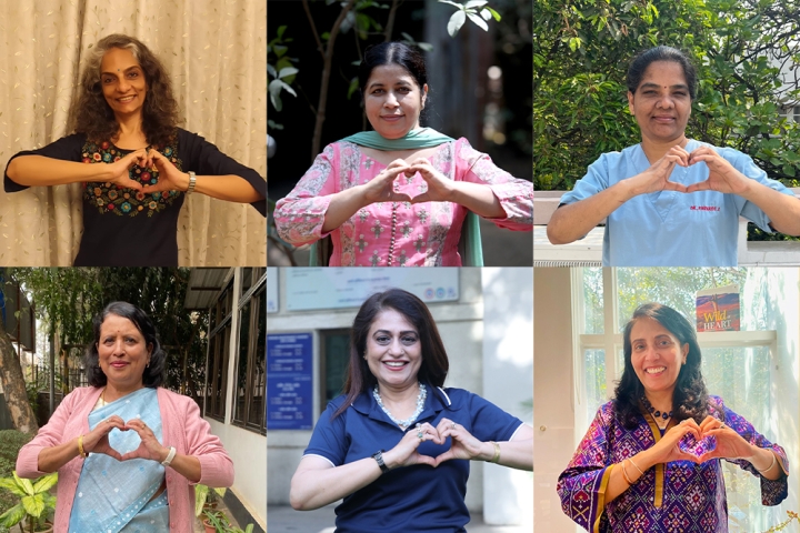 Smile Train India staff and partners smiling and holding up the International Womens' Day heart sign