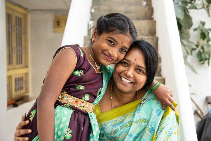 Akshara smiling and hugging her mother after cleft surgery