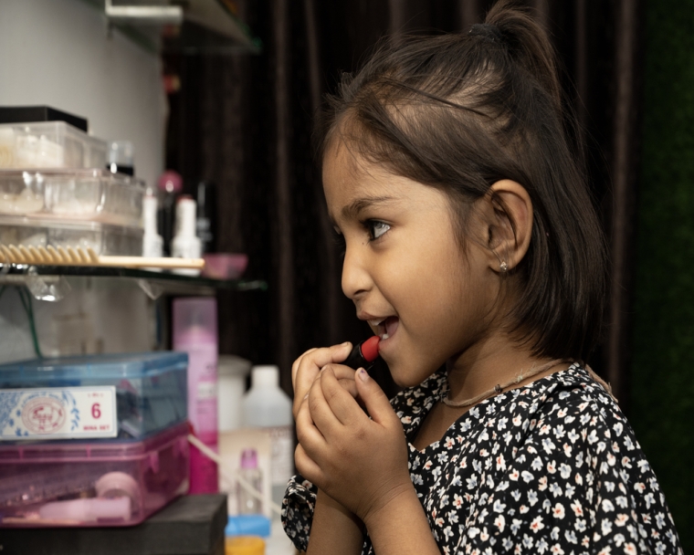 Sakshi applying lipstick after cleft surgery