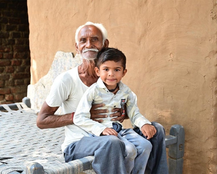 Jairaj smiling with his grandfather after cleft surgery