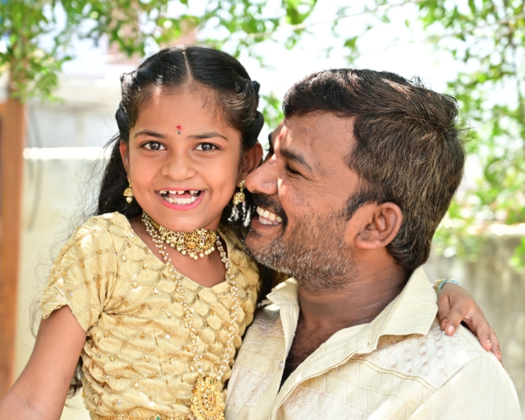 Pravallika smiling with her father after cleft surgery