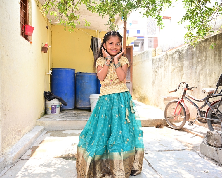 Pravallika standing and smiling after cleft surgery